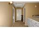 Bright hallway featuring a linen closet and neutral tones for a clean and modern look at 7456 W Via Montoya Dr, Glendale, AZ 85310