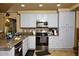 Modern kitchen with granite countertops, updated appliances, and ample cabinet space at 7456 W Via Montoya Dr, Glendale, AZ 85310
