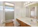 Bright bathroom featuring a vanity with ample countertop space and a glass-enclosed shower for a spa-like experience at 7625 W Dreyfus Dr, Peoria, AZ 85381
