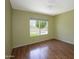 Simple room with hardwood floors and natural light from the window at 7625 W Dreyfus Dr, Peoria, AZ 85381