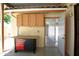 A covered patio features built-in cabinets and an open door for easy access to the inside at 7625 W Dreyfus Dr, Peoria, AZ 85381