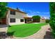 Two-story home with a spacious backyard, covered patio, and mature landscaping, offering privacy at 7625 W Dreyfus Dr, Peoria, AZ 85381
