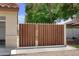Wooden gate with metal frame leading to backyard and garage at 7625 W Dreyfus Dr, Peoria, AZ 85381