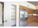 Kitchen pantry next to stainless steel refrigerator in a bright well lit kitchen at 7625 W Dreyfus Dr, Peoria, AZ 85381