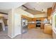 Open kitchen features stainless steel appliances, tile floors, and ample cabinet space at 7625 W Dreyfus Dr, Peoria, AZ 85381