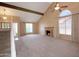 Bright and airy living area featuring high ceilings, a fireplace, and an open staircase at 7625 W Dreyfus Dr, Peoria, AZ 85381