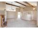 Spacious living room featuring a cozy fireplace, vaulted ceilings with beams, and a staircase at 7625 W Dreyfus Dr, Peoria, AZ 85381