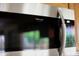 Close-up of a stainless steel Frigidaire Gallery microwave with digital display in the kitchen at 7625 W Dreyfus Dr, Peoria, AZ 85381