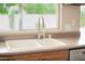 Close-up of the kitchen sink with a modern faucet and a view of the backyard through the window at 7625 W Dreyfus Dr, Peoria, AZ 85381
