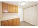 Storage area with wooden cabinets and a white countertop, perfect for organization at 7625 W Dreyfus Dr, Peoria, AZ 85381