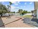 Landscaped backyard featuring a pool, fire pit, and desert landscaping with palm trees at 842 E Village Circle N Dr, Phoenix, AZ 85022