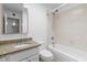 Bathroom with tub/shower combo, granite vanity, and tiled shower walls at 842 E Village Circle N Dr, Phoenix, AZ 85022