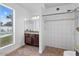 Bathroom with bright window, tiled shower, and granite vanity with dark cabinets at 842 E Village Circle N Dr, Phoenix, AZ 85022