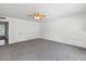 Neutral carpeted bedroom features dual closets, a ceiling fan, and ample natural light at 842 E Village Circle N Dr, Phoenix, AZ 85022