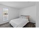 Neutral bedroom with a large window and a queen bed with light colored sheets at 842 E Village Circle N Dr, Phoenix, AZ 85022