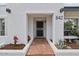 Inviting front entry with a brick walkway, desert landscaping, and a white exterior at 842 E Village Circle N Dr, Phoenix, AZ 85022