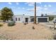 Inviting single-story home featuring desert landscaping, a two-car garage, and a freshly painted white exterior at 842 E Village Circle N Dr, Phoenix, AZ 85022