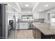 Modern kitchen with stainless steel appliances, white cabinets, and a large island at 842 E Village Circle N Dr, Phoenix, AZ 85022