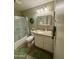This bathroom features a shower-tub combo with sliding doors, toilet, vanity and granite counters at 8632 E Thornwood Dr, Scottsdale, AZ 85251