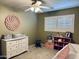 Bedroom with a ceiling fan, a large dresser, and a play area at 8632 E Thornwood Dr, Scottsdale, AZ 85251