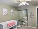 Bedroom with ceiling fan, cribs, and a mirrored closet at 8632 E Thornwood Dr, Scottsdale, AZ 85251