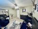Cozy Bedroom features a ceiling fan, modern dresser, crib and charming decor at 8632 E Thornwood Dr, Scottsdale, AZ 85251