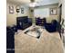 Bedroom featuring a ceiling fan, a crib, a reading area, and unique decorative features at 8632 E Thornwood Dr, Scottsdale, AZ 85251