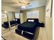 Comfortable bedroom featuring a mirrored closet, a ceiling fan, and modern decor at 8632 E Thornwood Dr, Scottsdale, AZ 85251