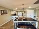Bright dining room featuring a dark wood table, bench seating, and stylish overhead lighting at 8632 E Thornwood Dr, Scottsdale, AZ 85251
