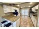 Well-lit kitchen featuring granite countertops, white cabinets, and stainless steel appliances at 8632 E Thornwood Dr, Scottsdale, AZ 85251