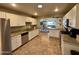 Bright kitchen with granite counters, stainless steel appliances, and ample cabinet storage at 8632 E Thornwood Dr, Scottsdale, AZ 85251