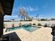 Stunning pool and spa combo surrounded by travertine tile, creating a luxurious backyard retreat at 8632 E Thornwood Dr, Scottsdale, AZ 85251