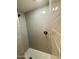 Bathroom shower featuring gray tile and a decorative circular tiled floor at 8632 E Thornwood Dr, Scottsdale, AZ 85251