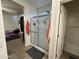 Bright bathroom featuring a glass-enclosed shower, a towel rack, and neutral tile flooring at 9825 W Trumbull Rd, Tolleson, AZ 85353