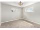 Bedroom with carpeted floors, a modern light fixture, and two windows that provide lots of natural light at 1010 W 5Th Pl, Mesa, AZ 85201