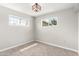 Bright bedroom features carpeted floors, a modern light fixture, and two windows that provide lots of natural light at 1010 W 5Th Pl, Mesa, AZ 85201