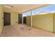 The carport area features a concrete floor, a brick wall, and access doors to the home's interior at 1010 W 5Th Pl, Mesa, AZ 85201