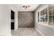 Well-lit dining area with a decorative accent wall and a view into the kitchen at 1010 W 5Th Pl, Mesa, AZ 85201
