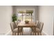 Bright dining room features a wood table, stylish chairs and sliding glass doors to outdoor space at 1010 W 5Th Pl, Mesa, AZ 85201