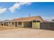 View of a single-story home, painted green, with a car port, and a large concrete driveway at 1010 W 5Th Pl, Mesa, AZ 85201
