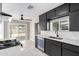 Contemporary kitchen with black cabinetry, white subway tile backsplash, and backyard access at 1010 W 5Th Pl, Mesa, AZ 85201
