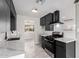 Modern kitchen featuring sleek black cabinets, stainless steel appliances, and white countertops at 1010 W 5Th Pl, Mesa, AZ 85201