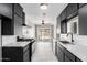 Bright kitchen featuring modern black cabinets, white countertops, and stainless steel appliances at 1010 W 5Th Pl, Mesa, AZ 85201