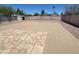 Spacious backyard with stone pavers, gravel, storage shed, and block fence for privacy at 1018 W Helena Dr, Phoenix, AZ 85023