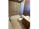 This bathroom features tile flooring, tiled shower walls, a vanity, and toilet at 1018 W Helena Dr, Phoenix, AZ 85023