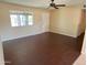This brightly lit living room has hard wood floors, fresh paint, and a ceiling fan at 1018 W Helena Dr, Phoenix, AZ 85023