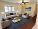 This well-staged living room showcases neutral walls, hardwood floors, and a ceiling fan at 1018 W Helena Dr, Phoenix, AZ 85023
