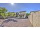 Spacious backyard featuring desert landscaping and a two-story home with solar panels at 11629 W Washington St, Avondale, AZ 85323