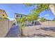 View of the low-maintenance backyard and house, featuring gravel and a privacy wall at 11629 W Washington St, Avondale, AZ 85323