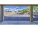 View of the low-maintenance backyard featuring a large gravel area with privacy wall and covered patio at 11629 W Washington St, Avondale, AZ 85323